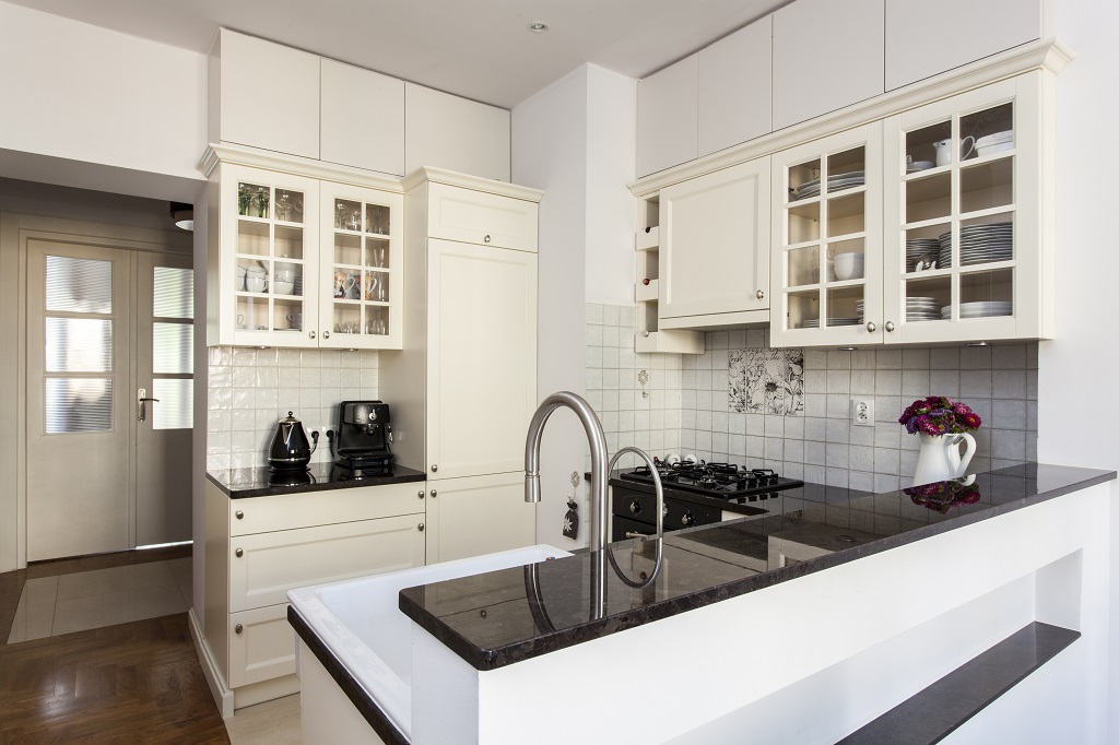 Black quartz countertop in white kitchen 